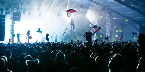 Large concert crowd under bright stage lights