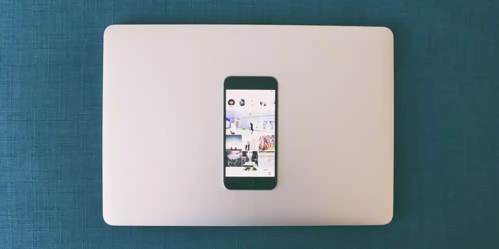 A phone, notebook and calendar laid out while planning a ticket sales campaign