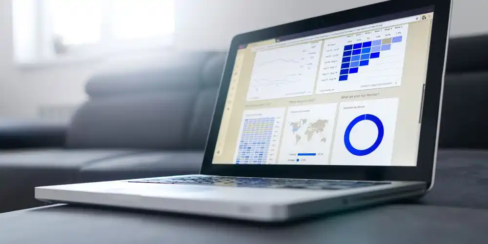 Laptop showing analytics dashboards in a bright office